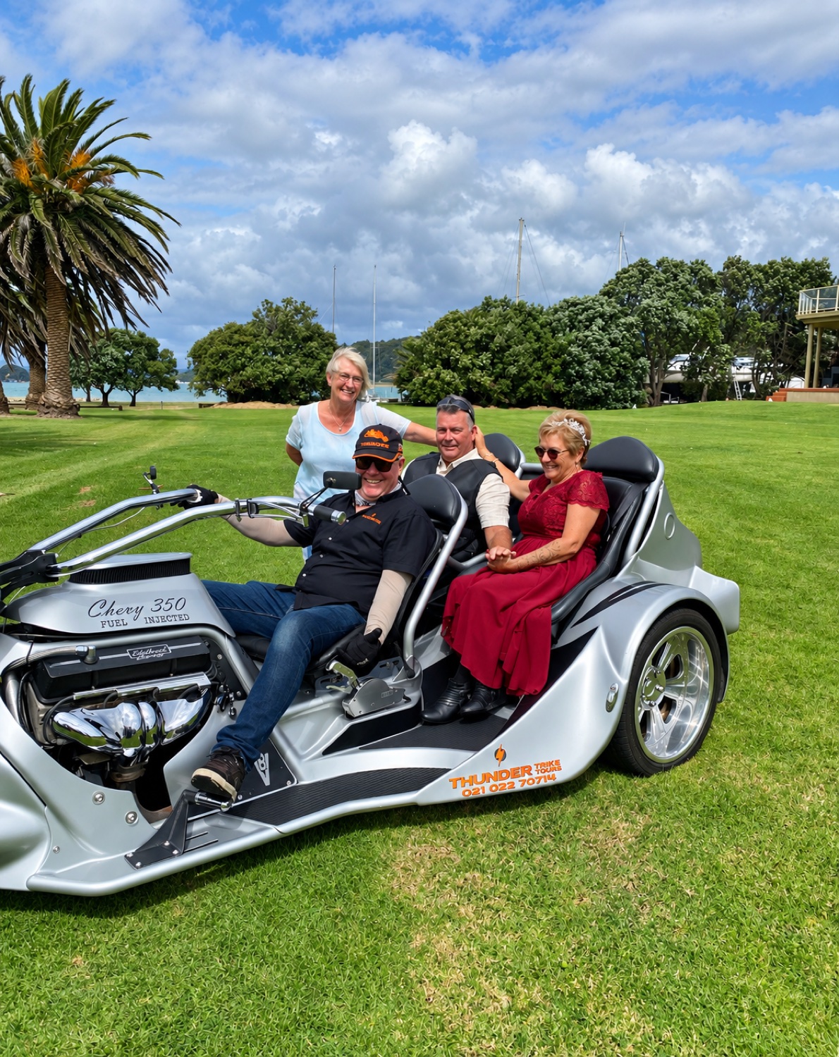 A wedding party arriving on a motor trike